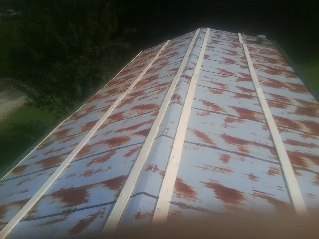 Rusted metal roof panels with new wood purlins before replacement — Storm Damage Roof Repair in Mamou by Roofing Brothers